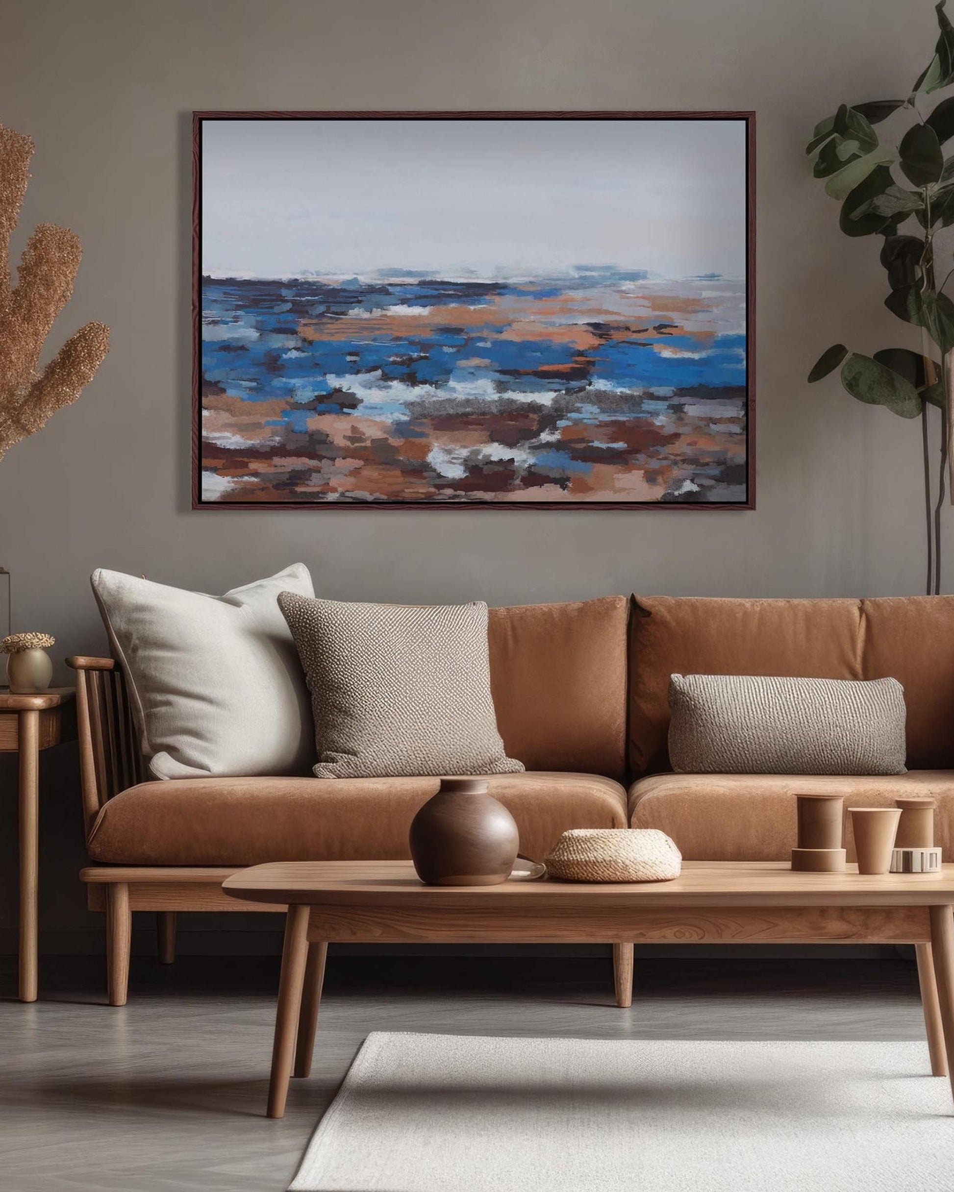Cozy living room with a brown sofa, wooden coffee table, and abstract painting on the wall.