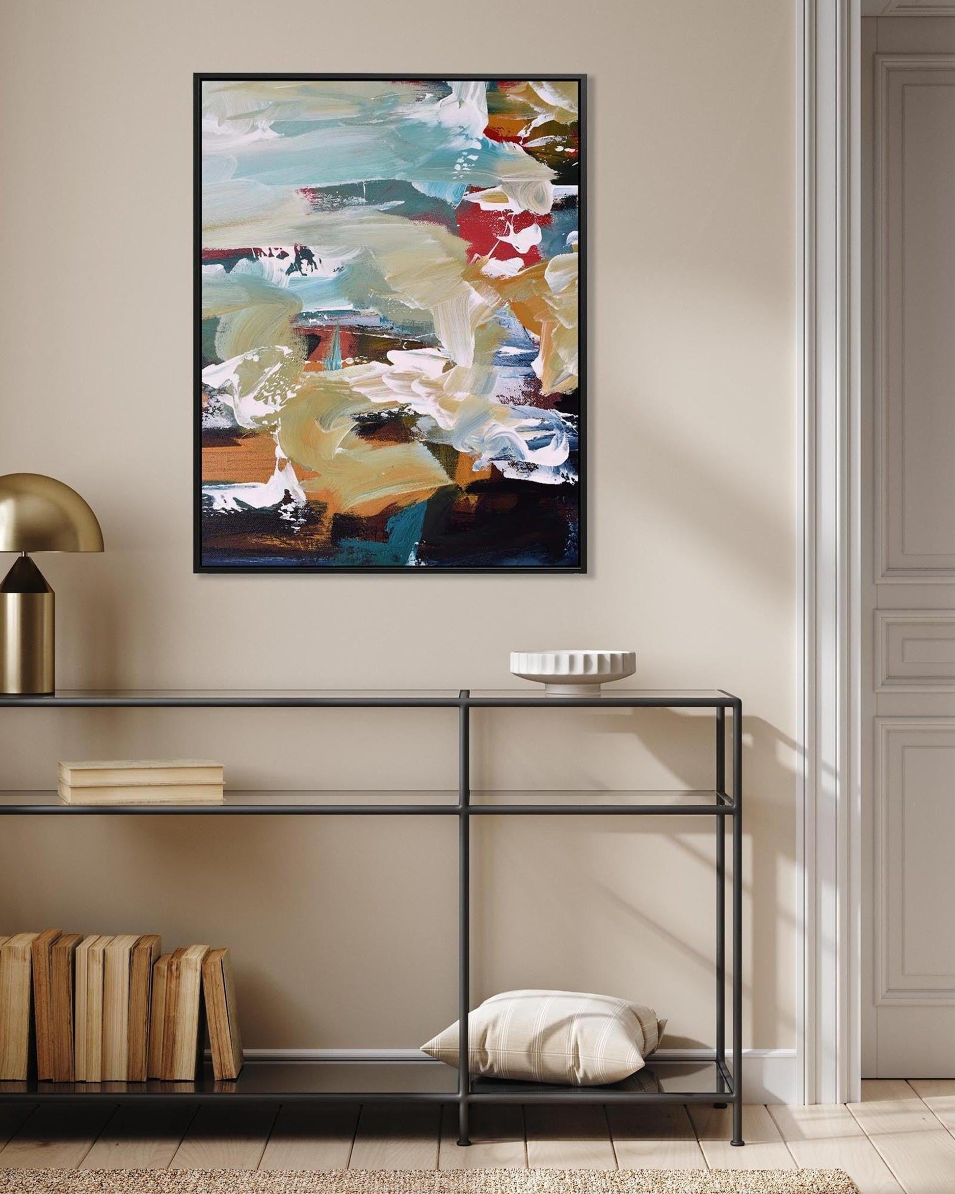 Modern interior with a console table, abstract painting, and decorative items.