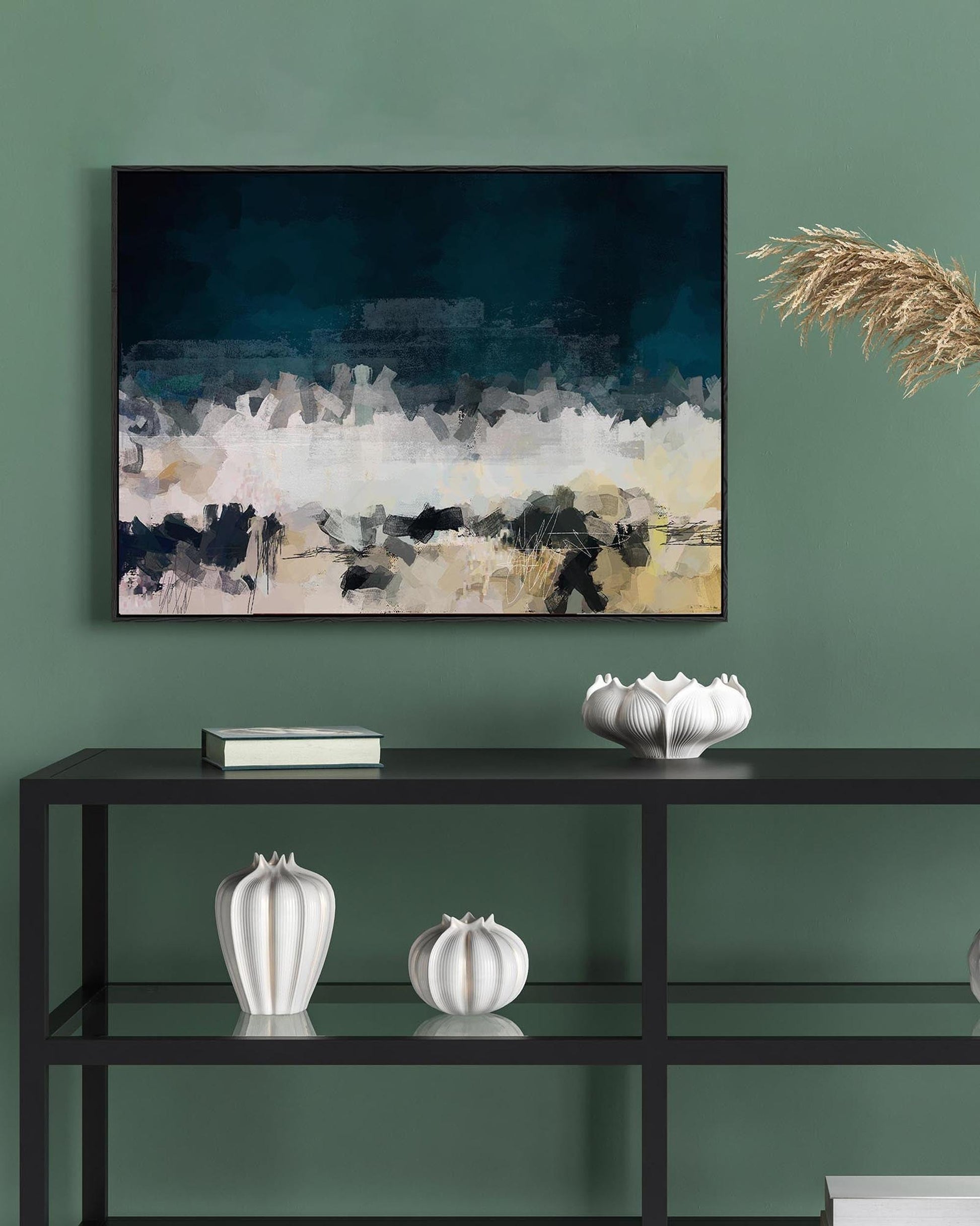 Abstract painting on a green wall with decorative items on a shelf below.
