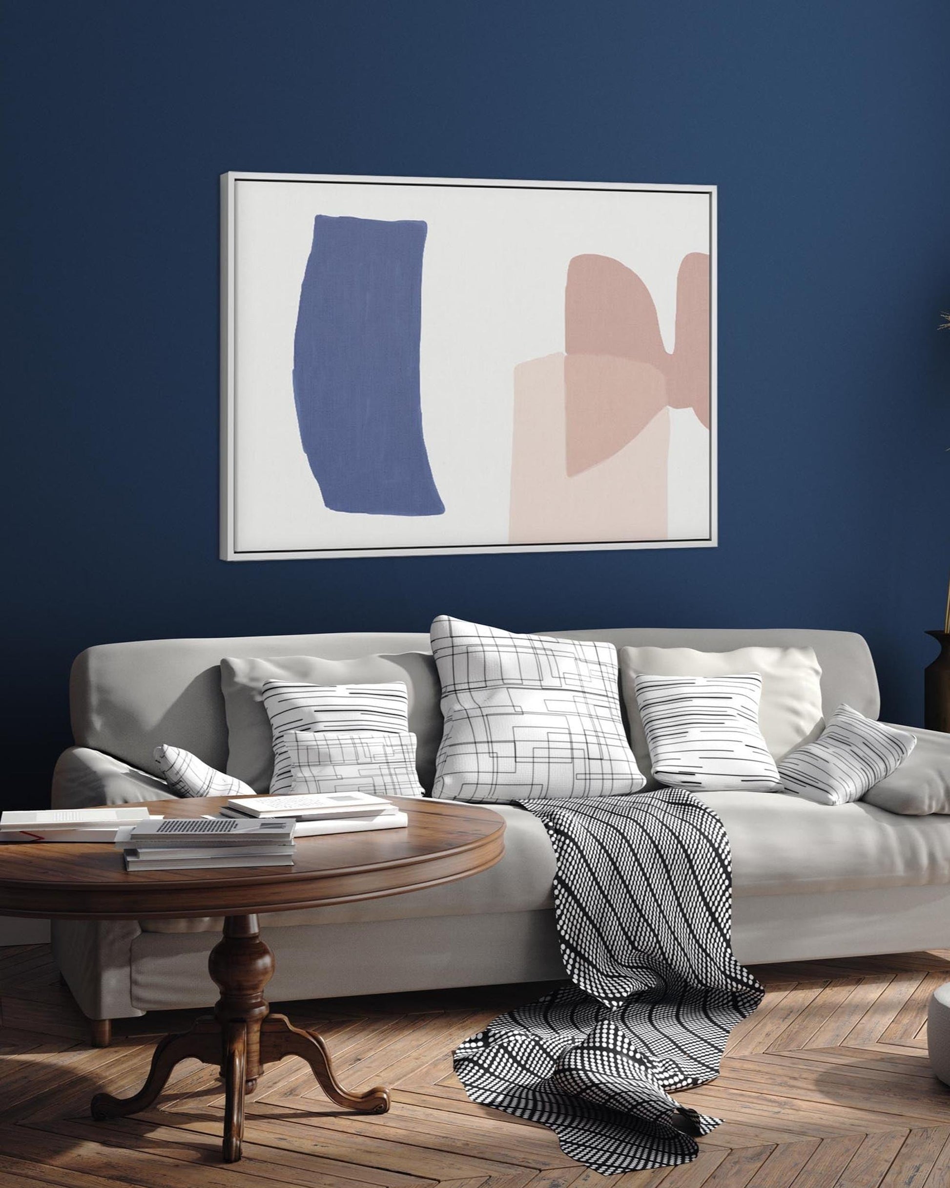 Living room with a gray sofa, abstract art on the wall, and a wooden coffee table.