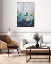 Modern living room with a brown chair, white sofa, wooden coffee table, and abstract painting.