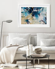 Living room with a white sofa, abstract art on the wall, and a coffee table with decor items.