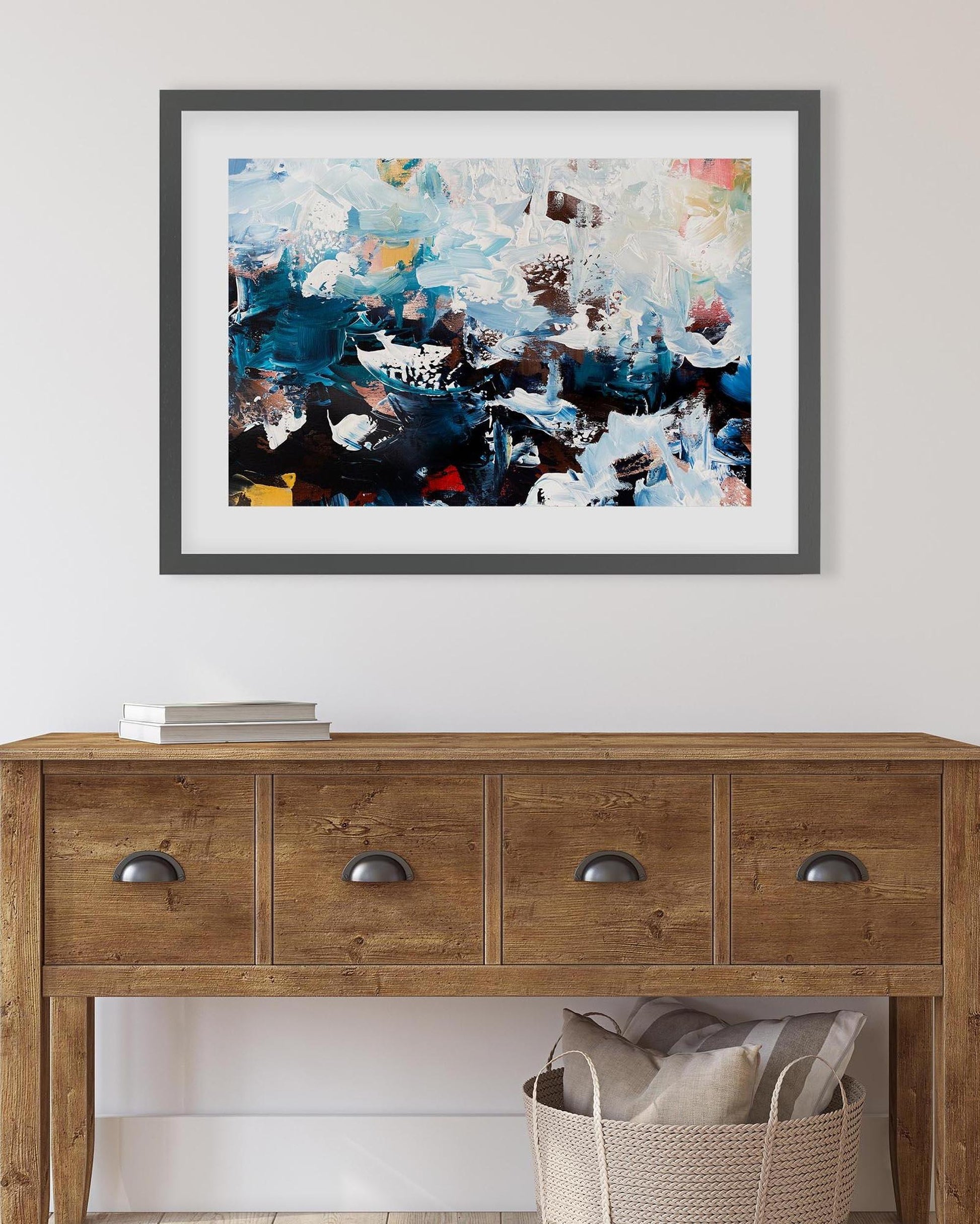 Abstract painting on a wall above a wooden console table.