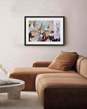 Modern living room with a brown sectional sofa, round coffee table, and abstract art on the wall.