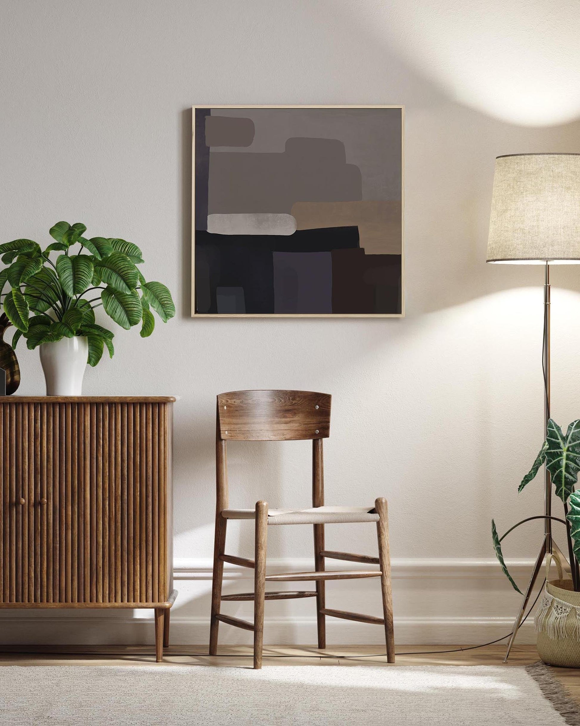 Modern interior with wooden cabinet, chair, and abstract art on a white wall.