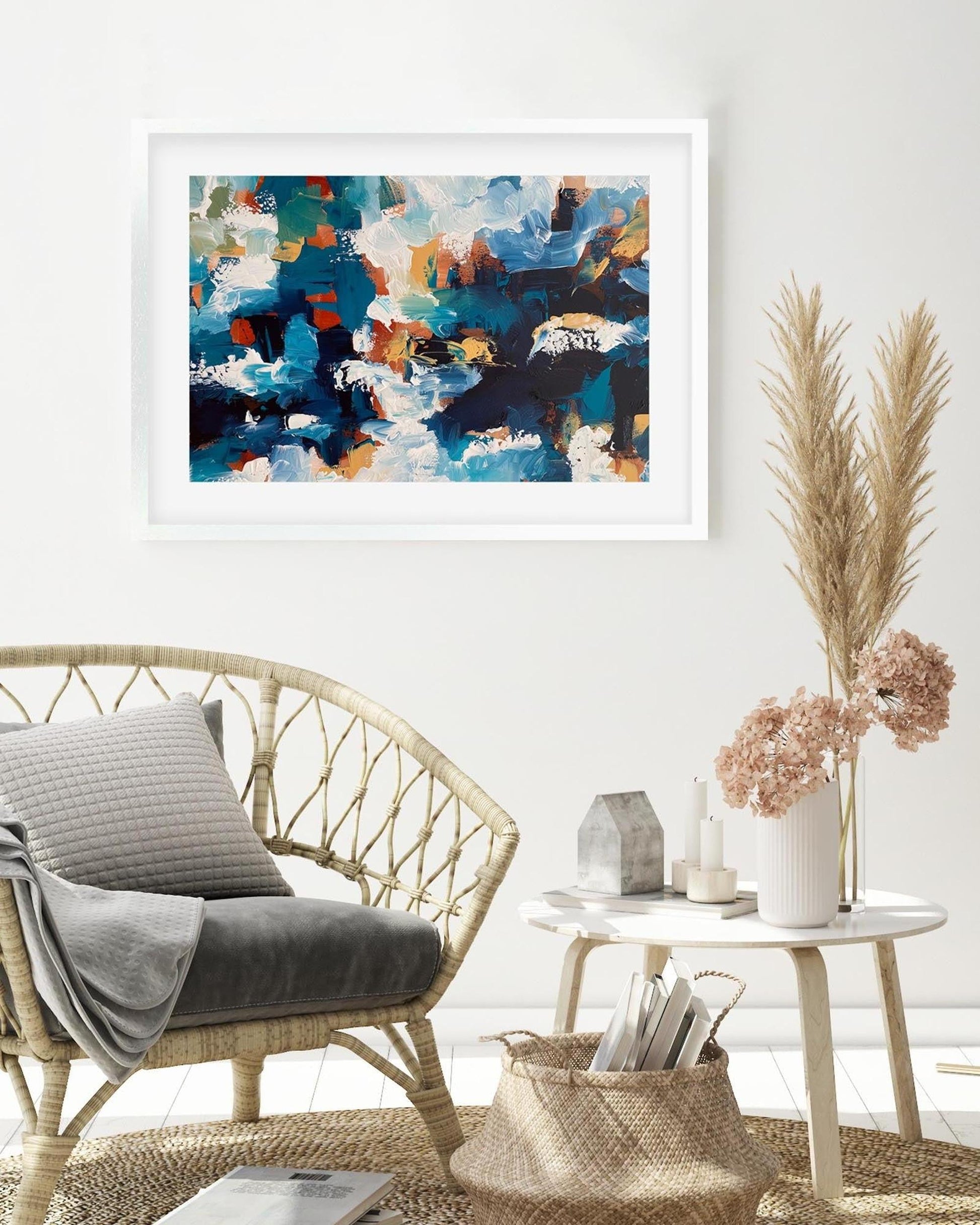 Living room with a wicker chair, abstract art on the wall, and decorative elements.