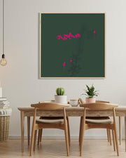 Dining room with wooden table and chairs, framed artwork on the wall, and potted plants.