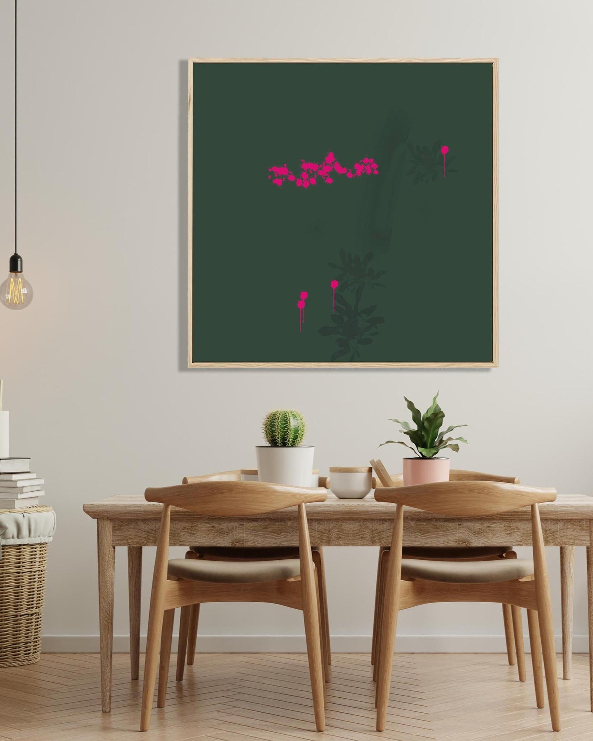Dining room with wooden table and chairs, framed artwork on the wall, and potted plants.