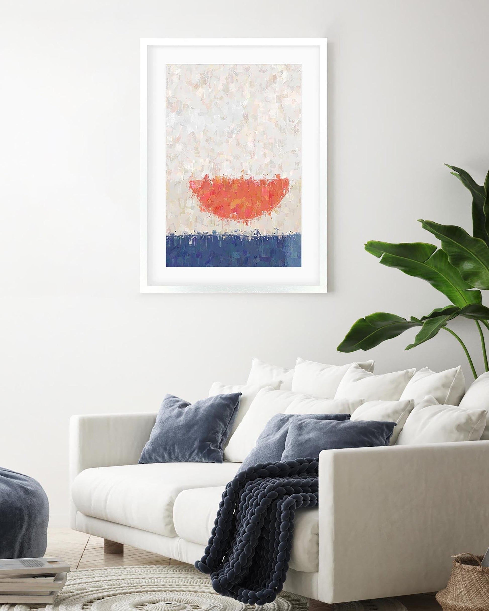 Living room with a white sofa, blue pillows, and a colorful abstract painting on the wall.
