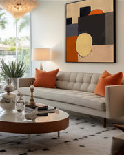 mid century modern abstract canvas art on a wall above a sofa