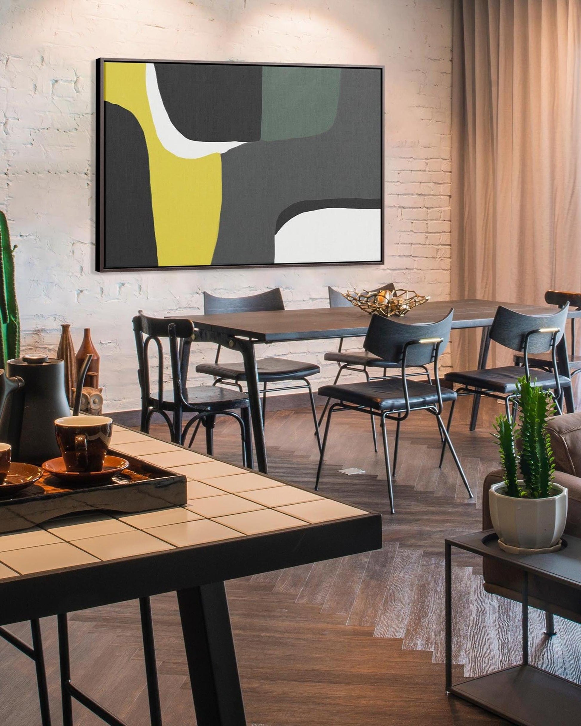 Modern dining room with abstract art on the wall and stylish furniture.