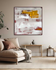 Living room with a beige sofa, abstract painting on the wall, and a small table with decorative items.
