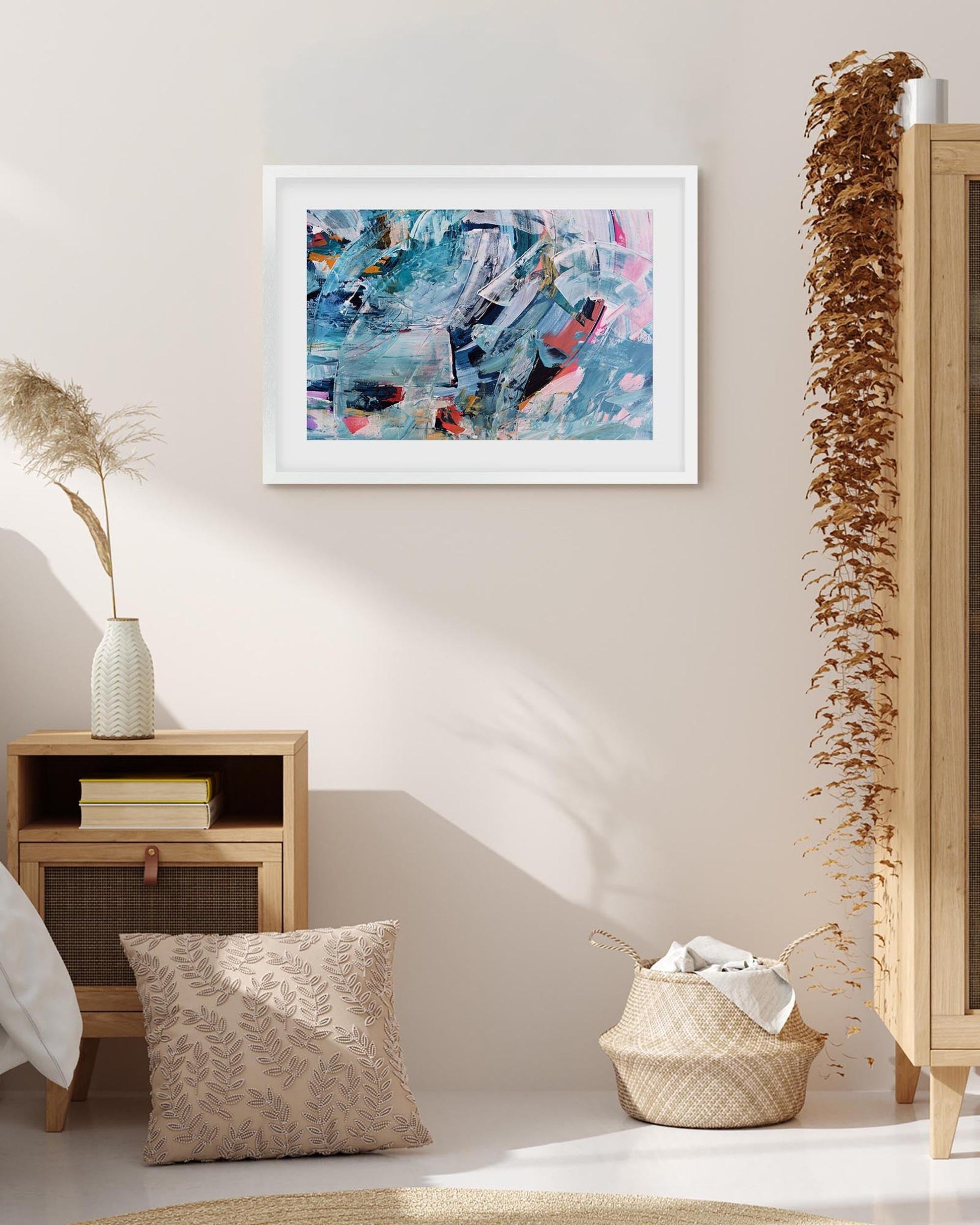 Framed abstract art piece on a wall in a room with decorative elements.