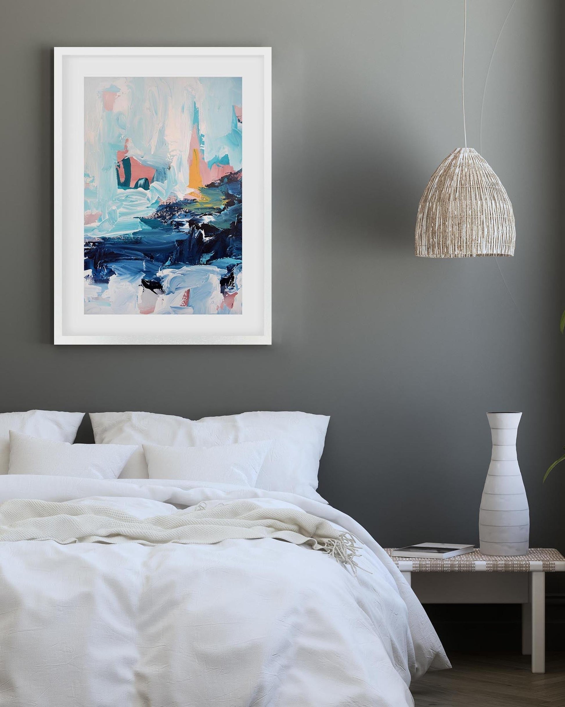 Modern bedroom with abstract art on the wall, white bedding, and a vase on a nightstand.