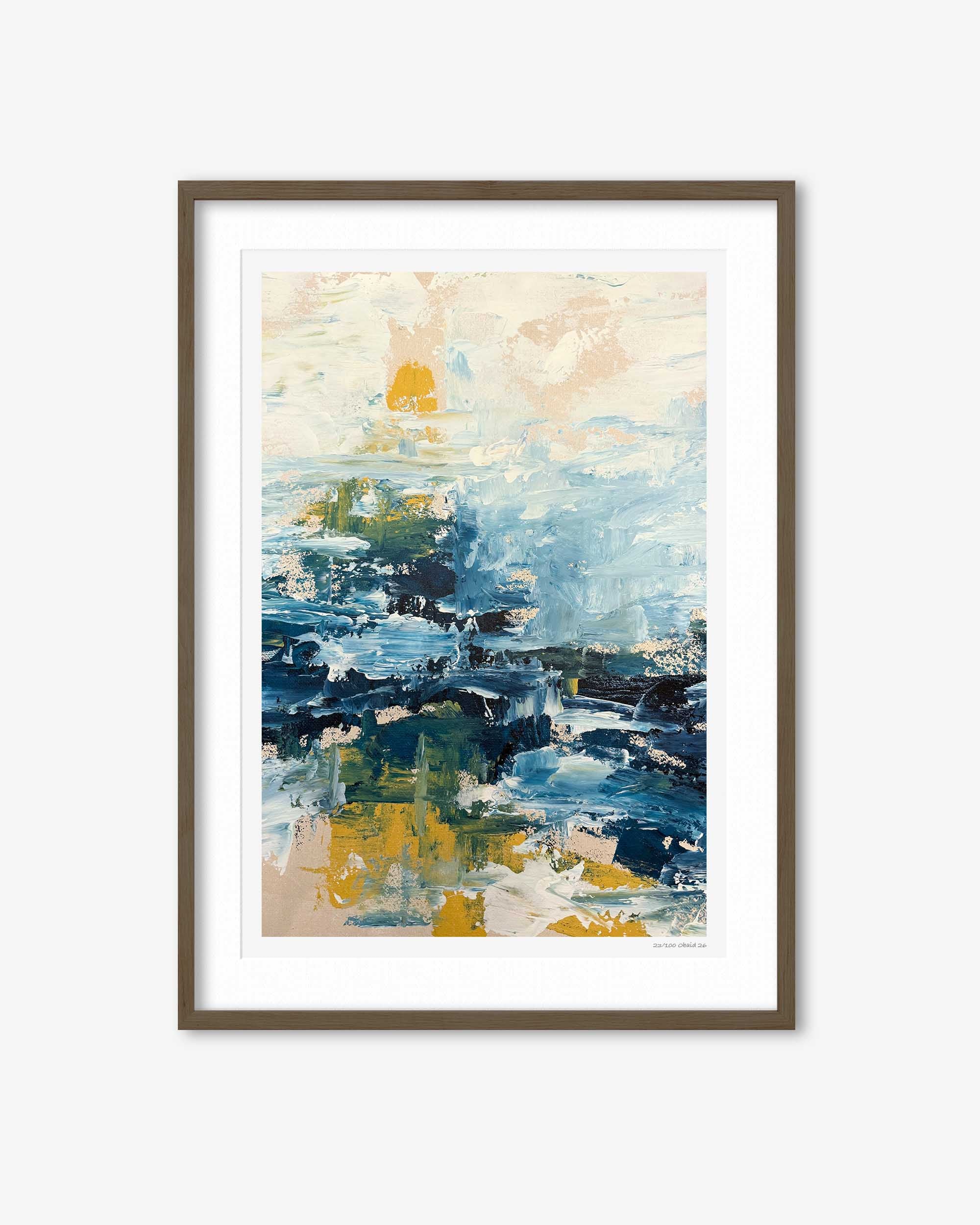 Framed abstract art print with blue, yellow, and beige colors on a white wall.
