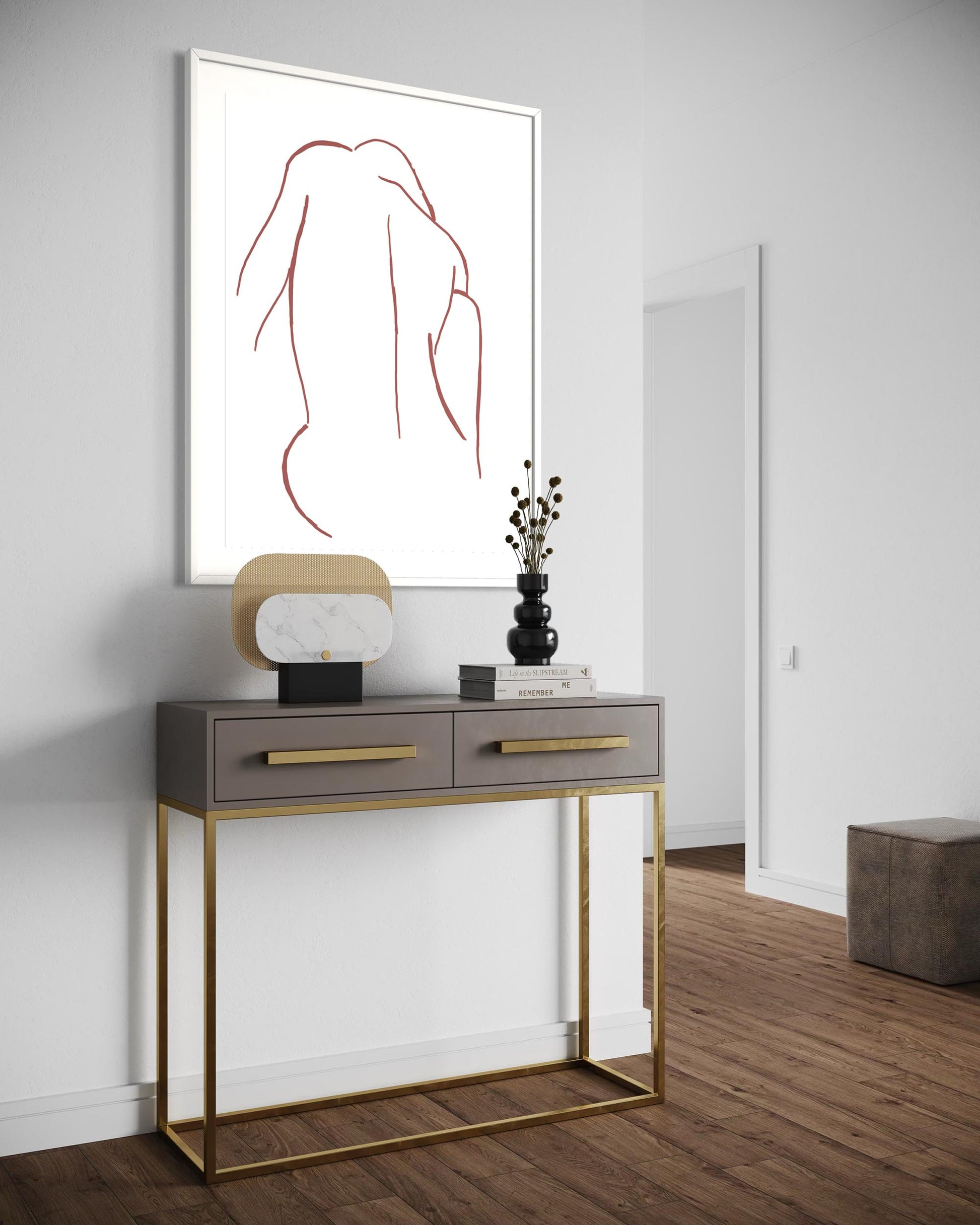 Modern console table with gold legs and gray top against a white wall with abstract art.