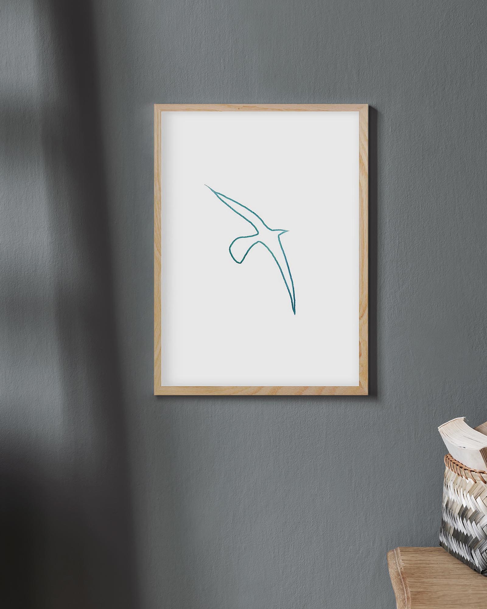 Framed artwork with a blue abstract design on a gray wall.
