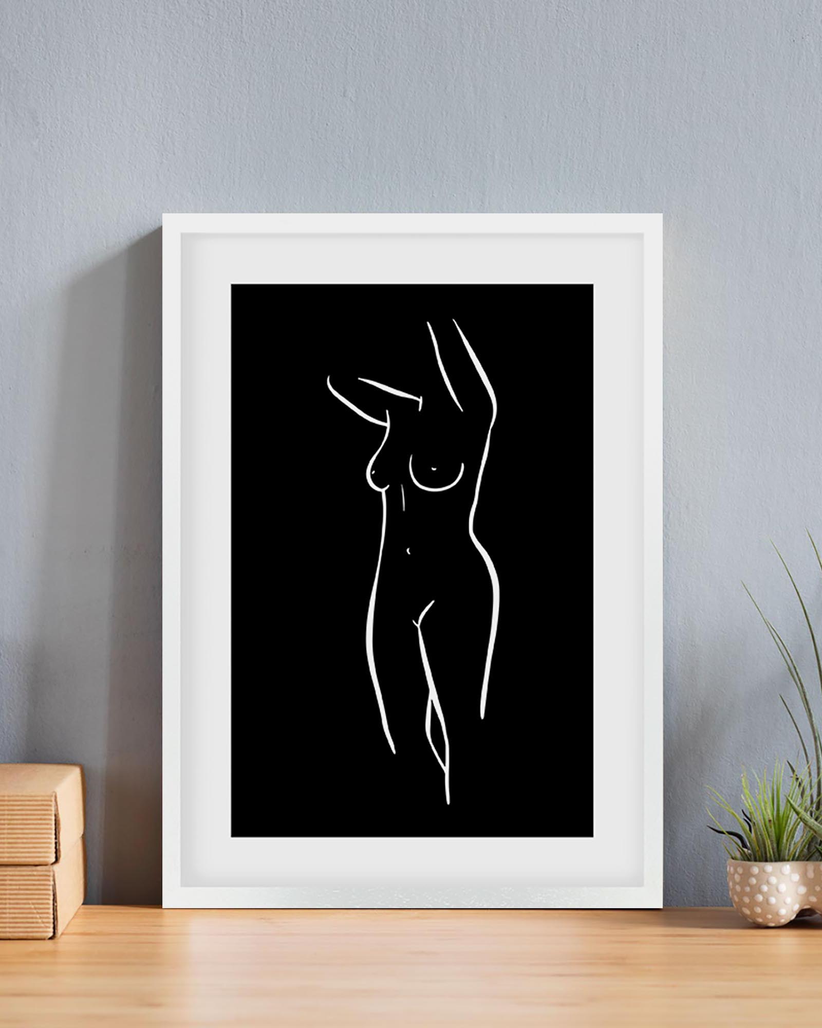 Framed black and white line art of a nude figure on a gray wall.