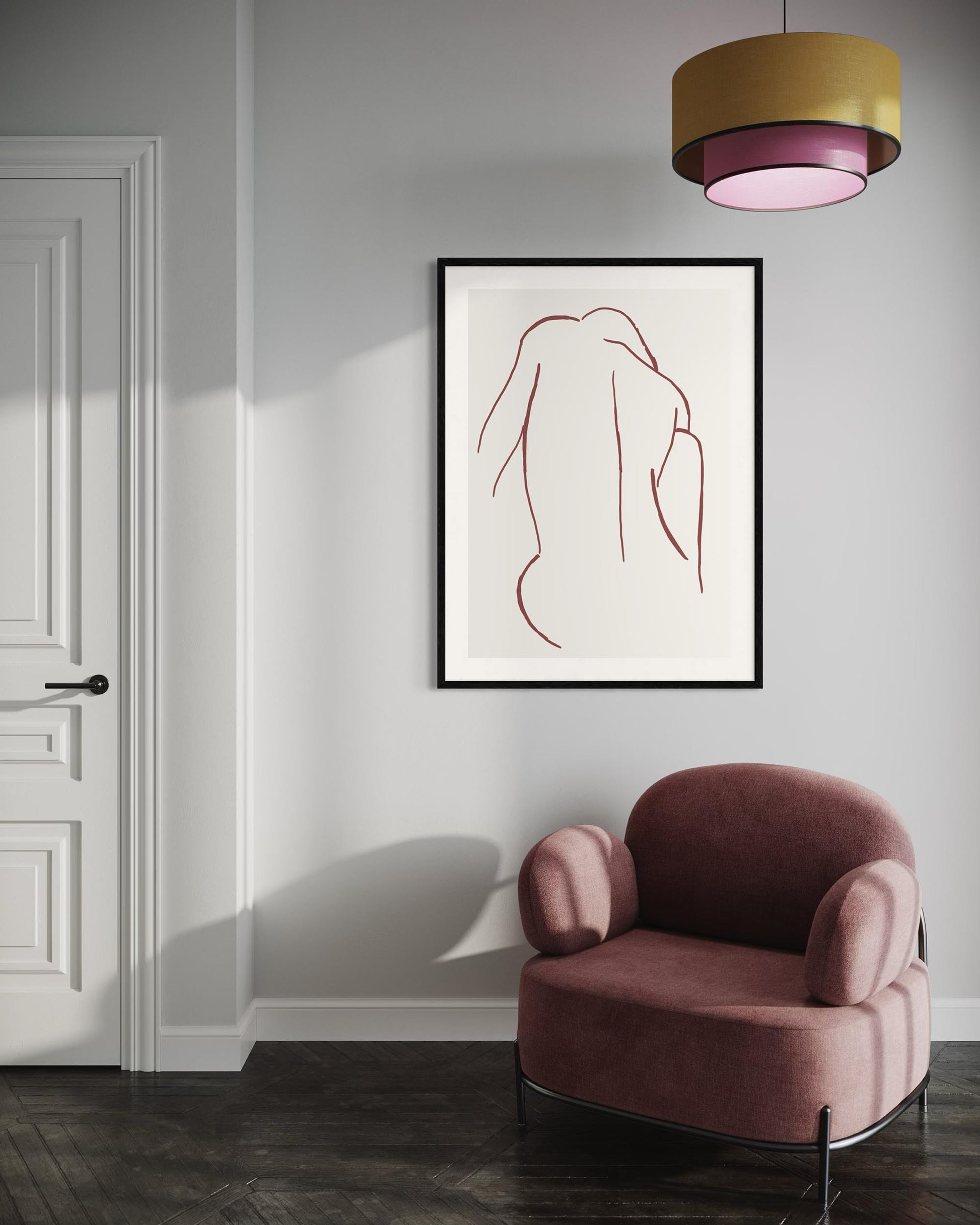 Modern interior with a pink armchair and abstract art on the wall.