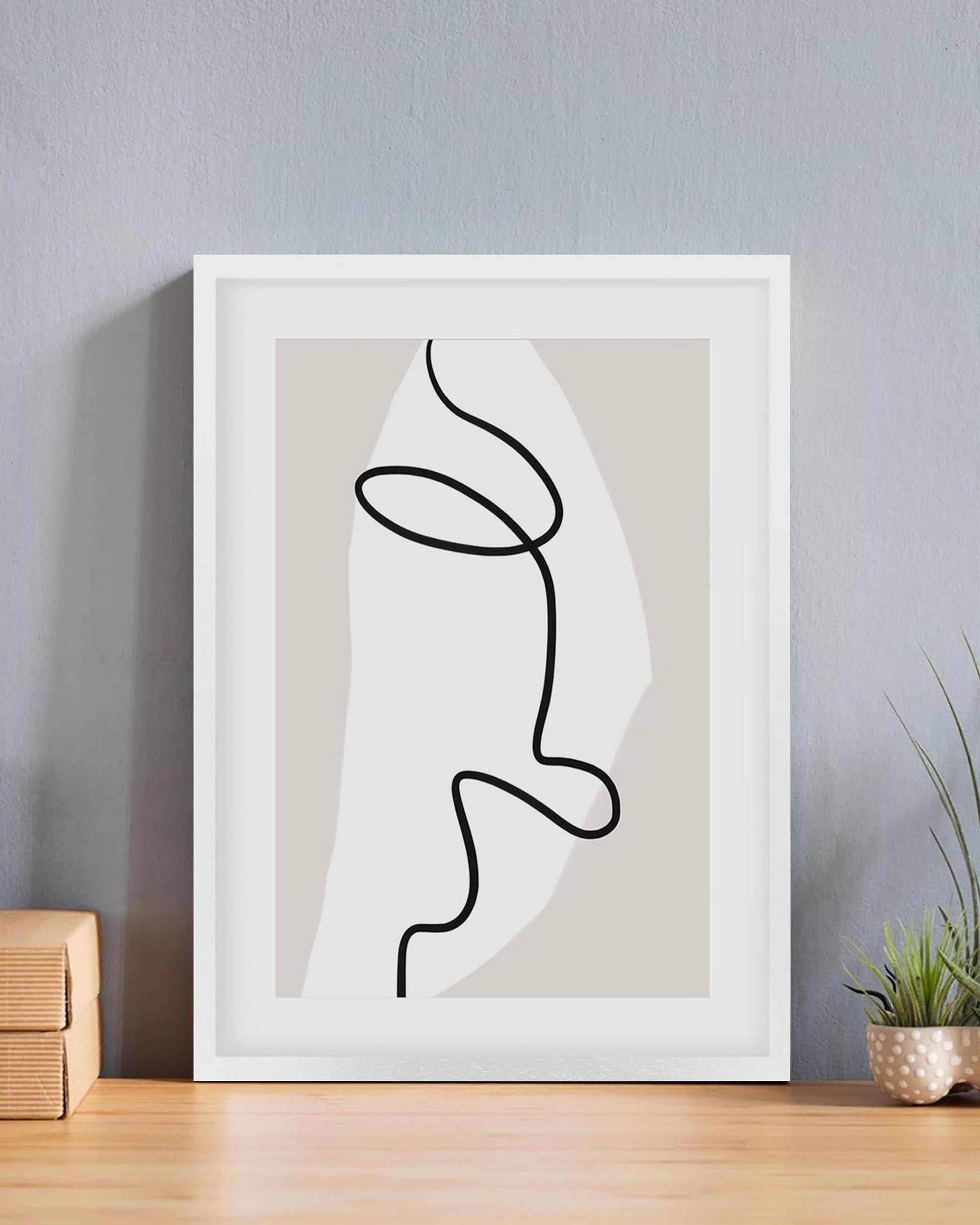 Framed abstract line art of a face on a neutral background