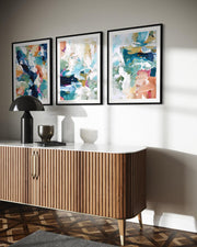 Modern interior with a wooden sideboard, abstract art, and decorative items.