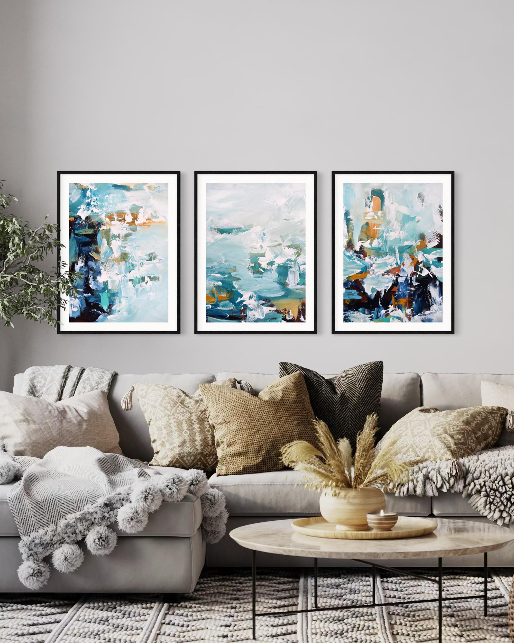 Living room with a gray sofa, abstract art prints on the wall, and decorative items.