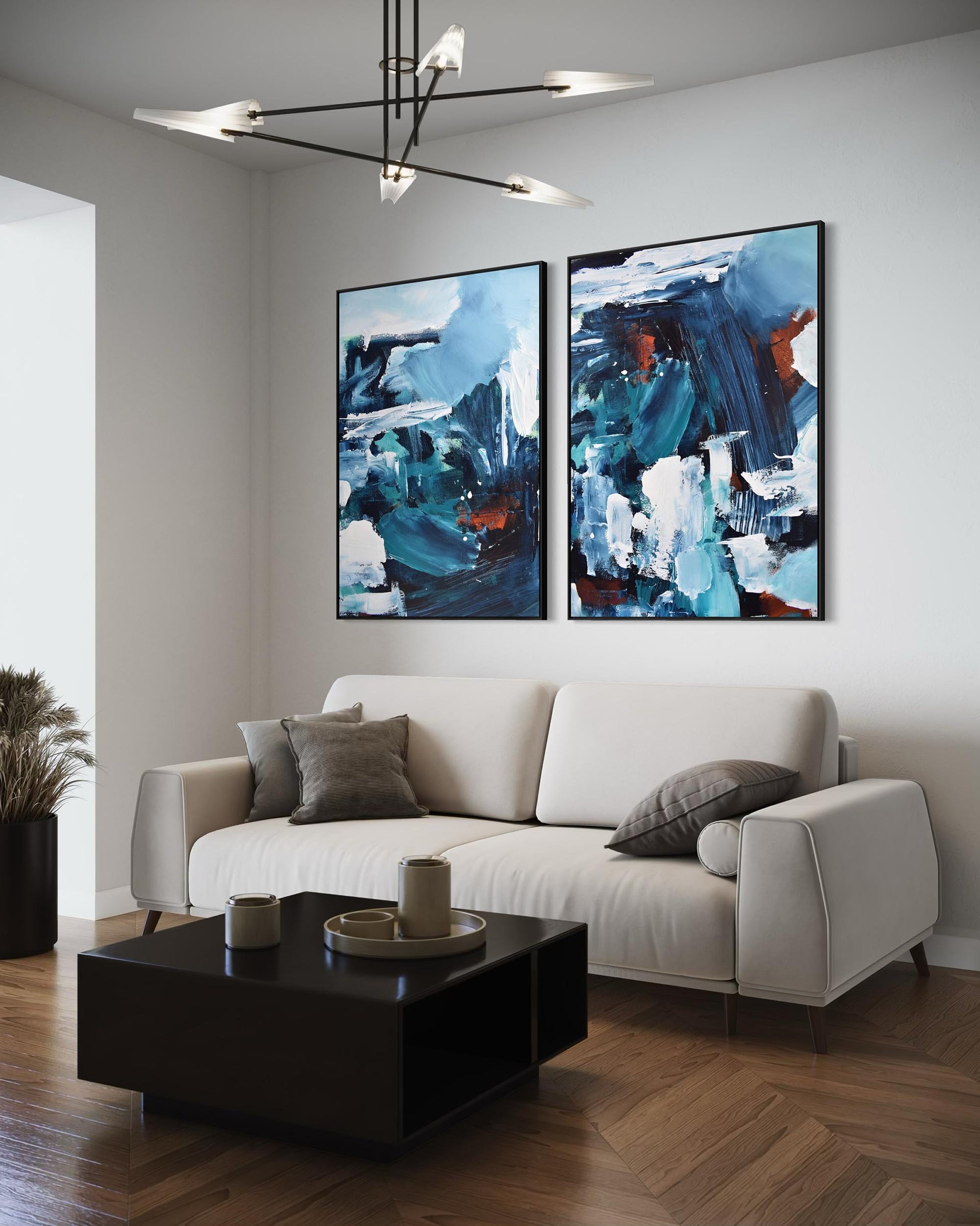 Modern living room with a white sofa, black coffee table, and abstract paintings on the wall.