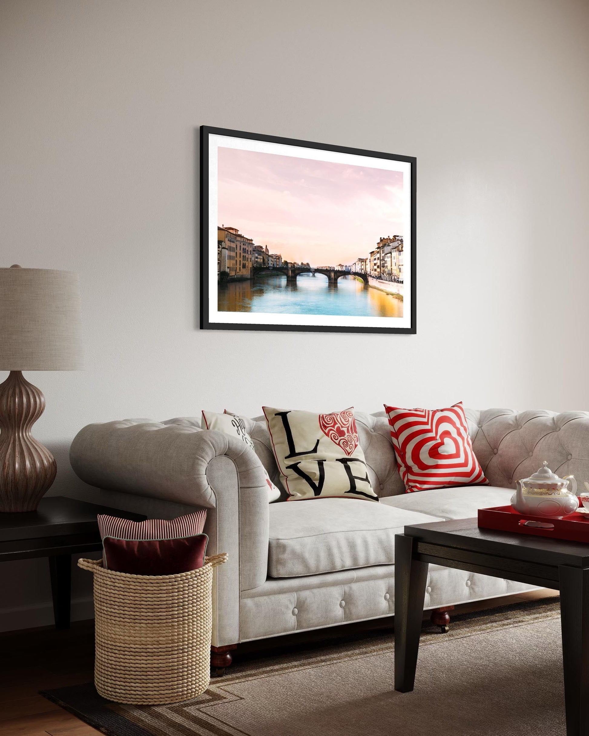 Living room with a couch, lamp, and framed artwork on the wall.