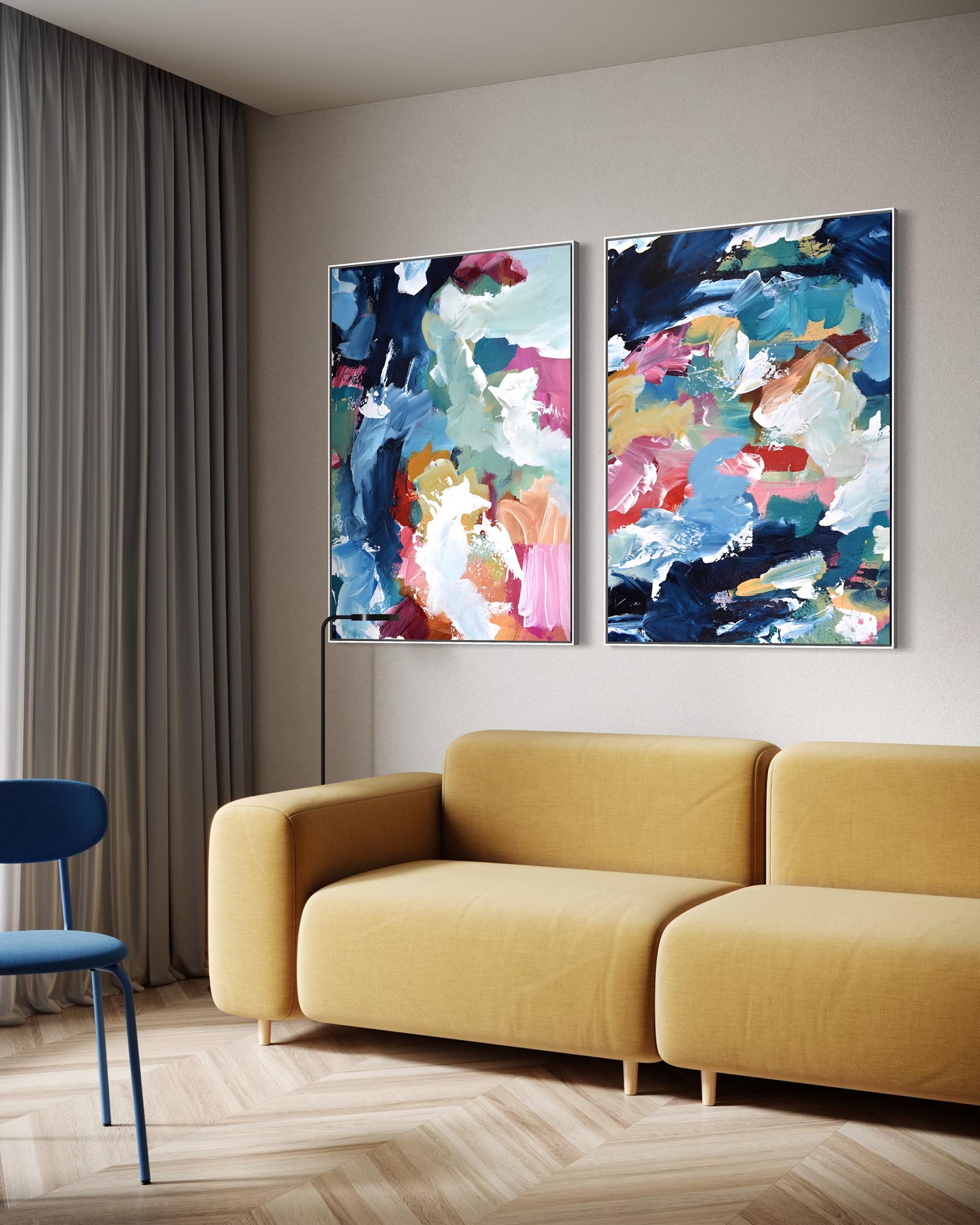Two abstract paintings on a wall above a yellow sofa in a living room.