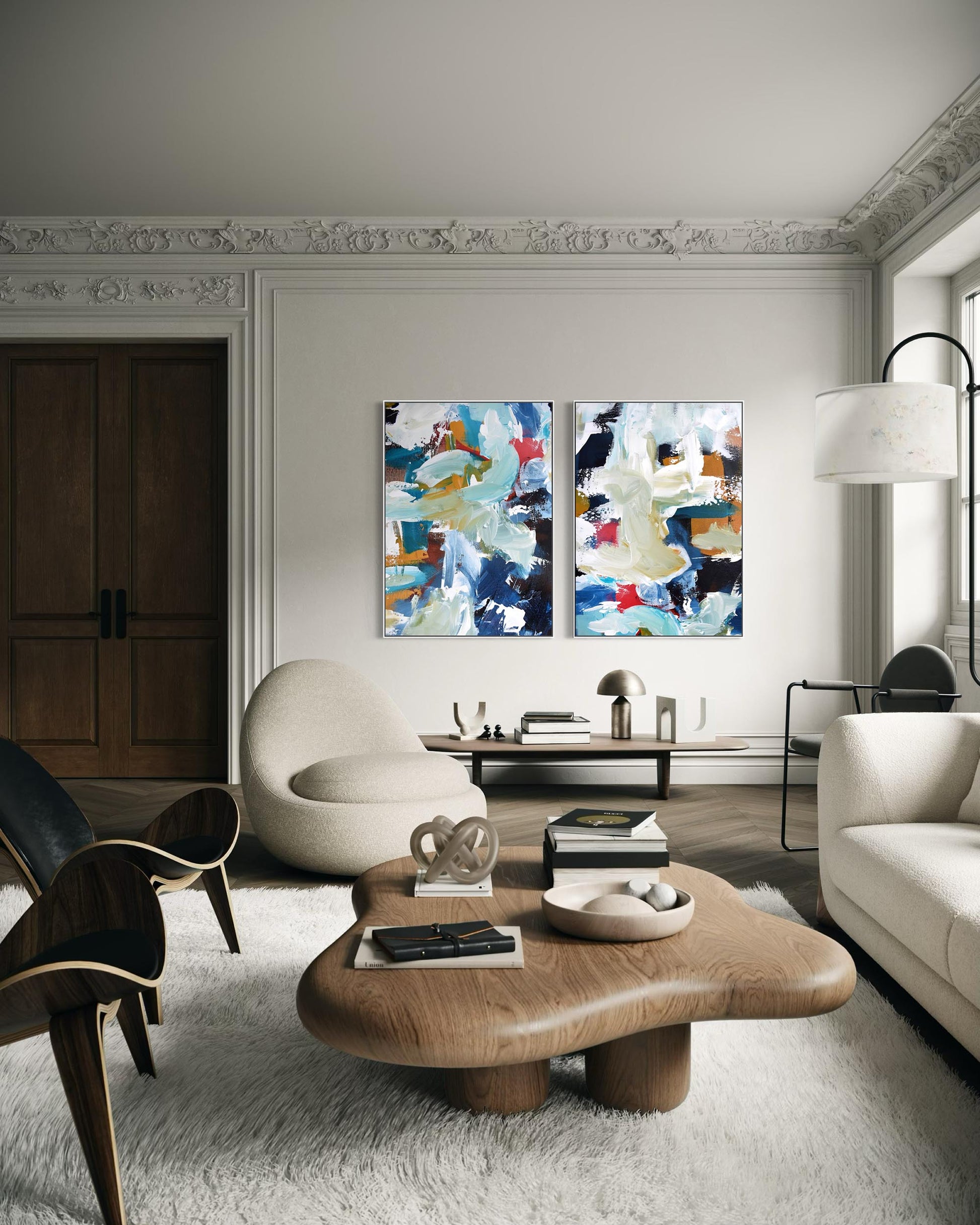 Modern living room with abstract art, wooden coffee table, and white sofa.