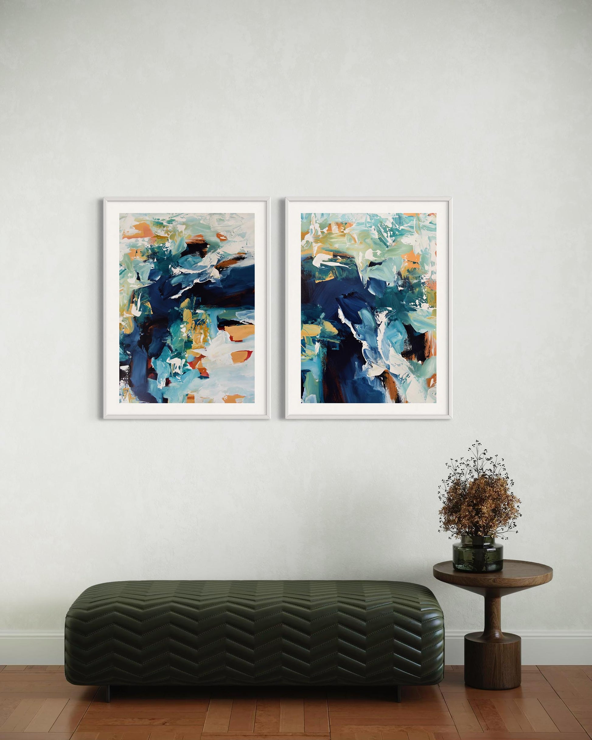 Two abstract art pieces on a wall with a bench and small table below.