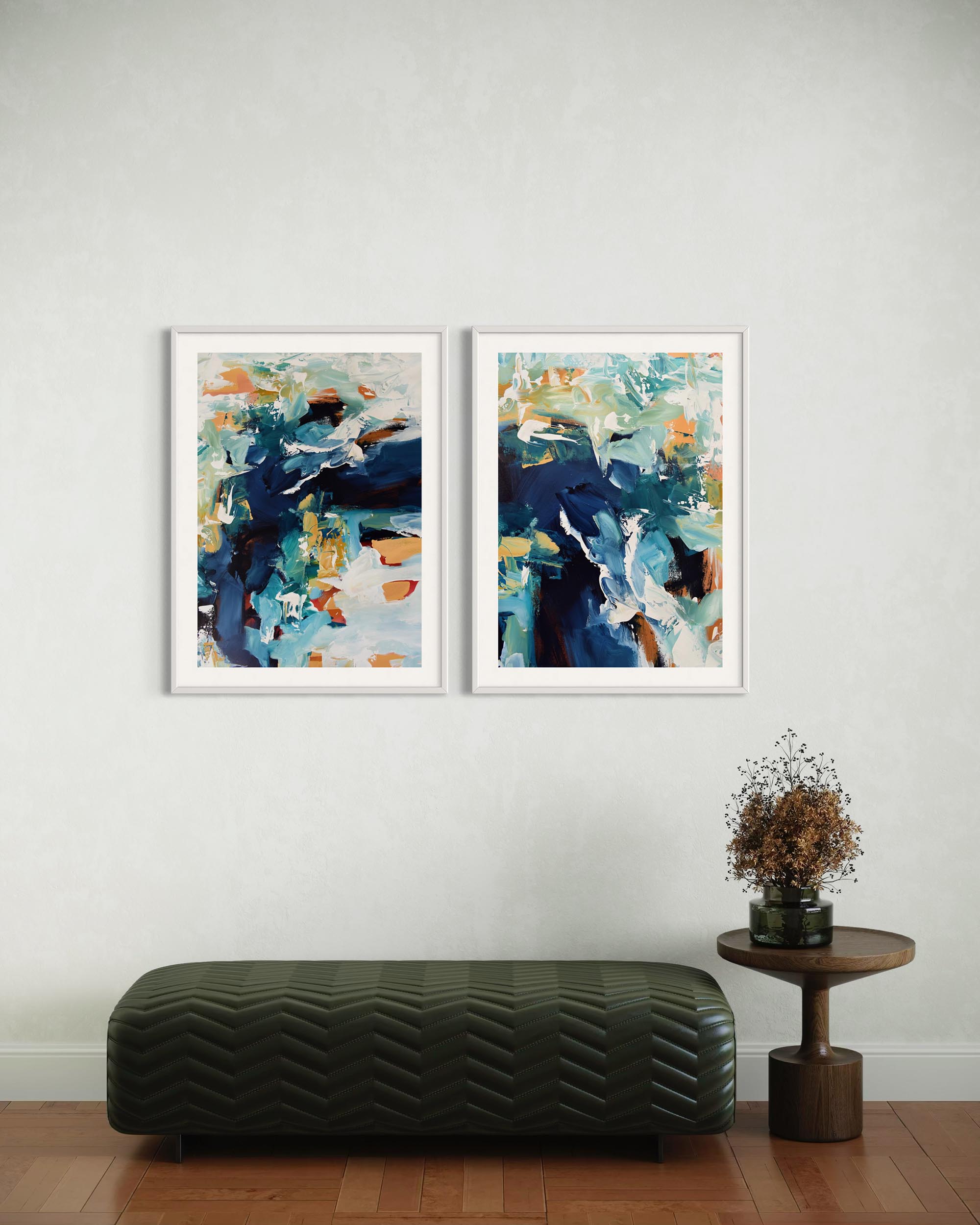 Two abstract art pieces on a wall with a bench and small table below.