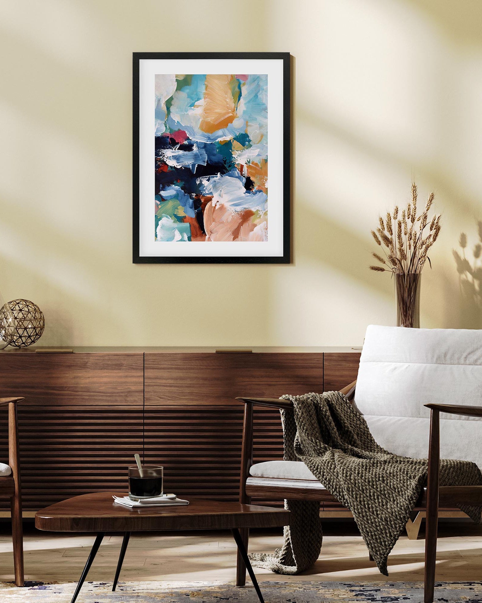 Modern living room with a colorful abstract painting on the wall, wooden coffee table, and white sofa.