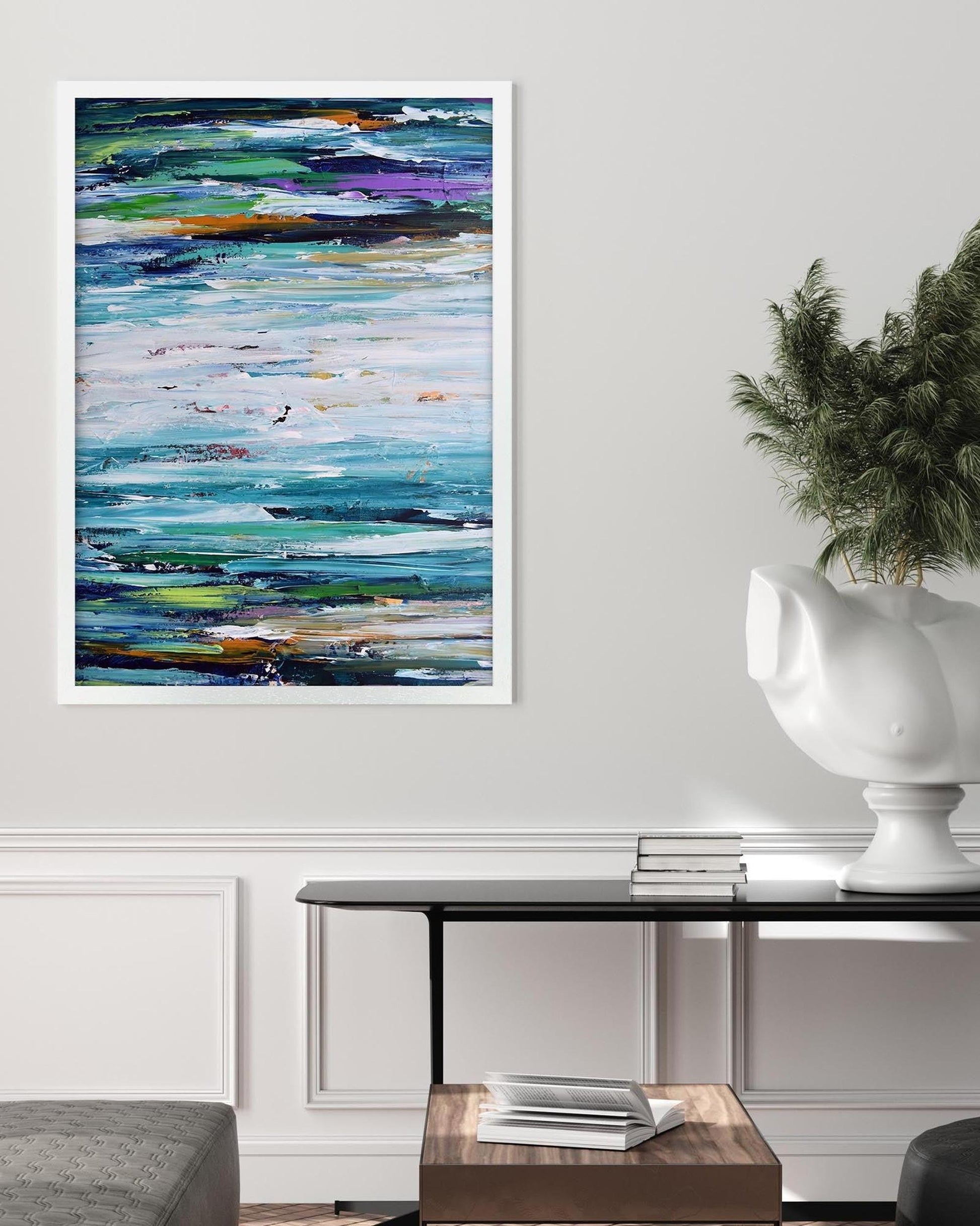 Abstract painting in a modern living room setting with a table and plant.