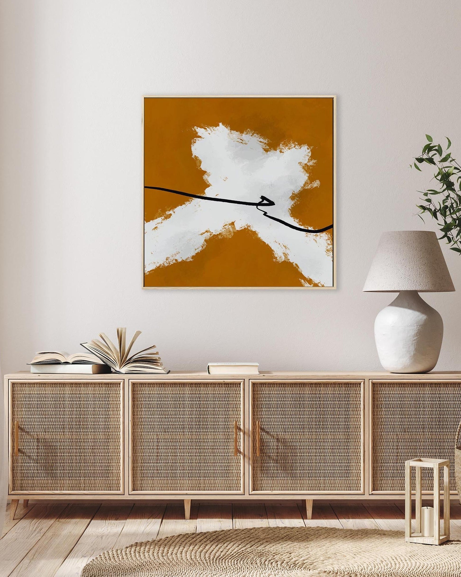 Modern interior with a sideboard, abstract art, and a lamp.