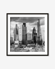 Framed black and white cityscape print of a skyline with modern buildings.