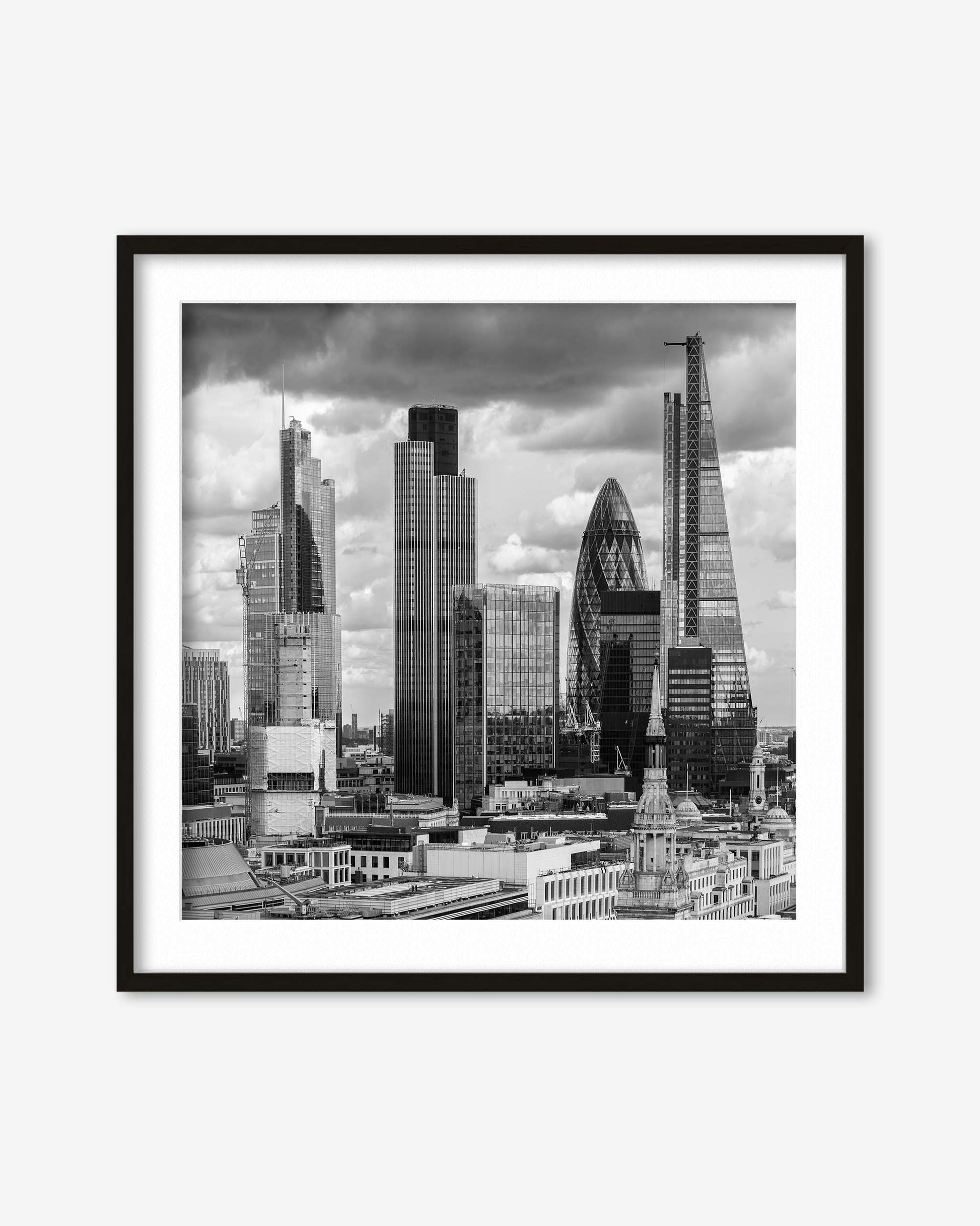 Framed black and white cityscape print of a skyline with modern buildings.