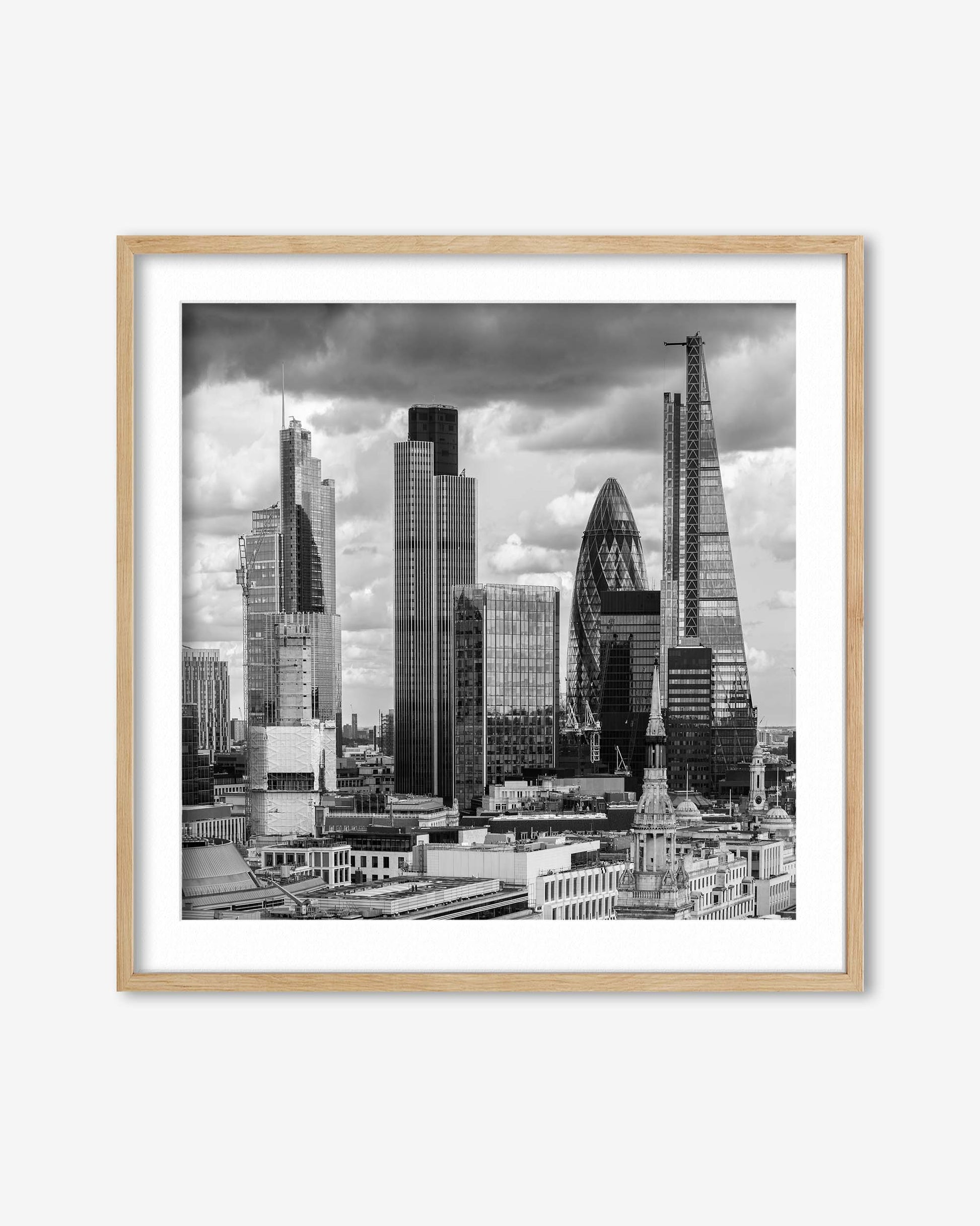 Framed black and white cityscape print of a skyline with modern buildings.