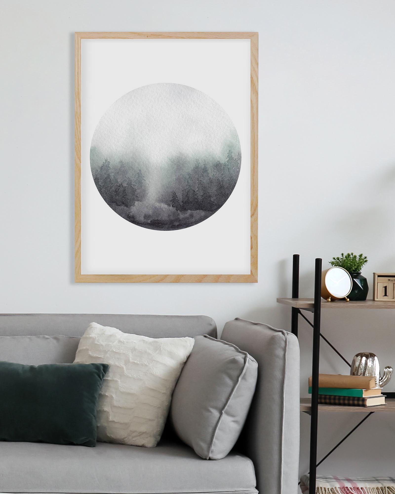 Framed circular artwork on a wall above a sofa with decorative pillows.