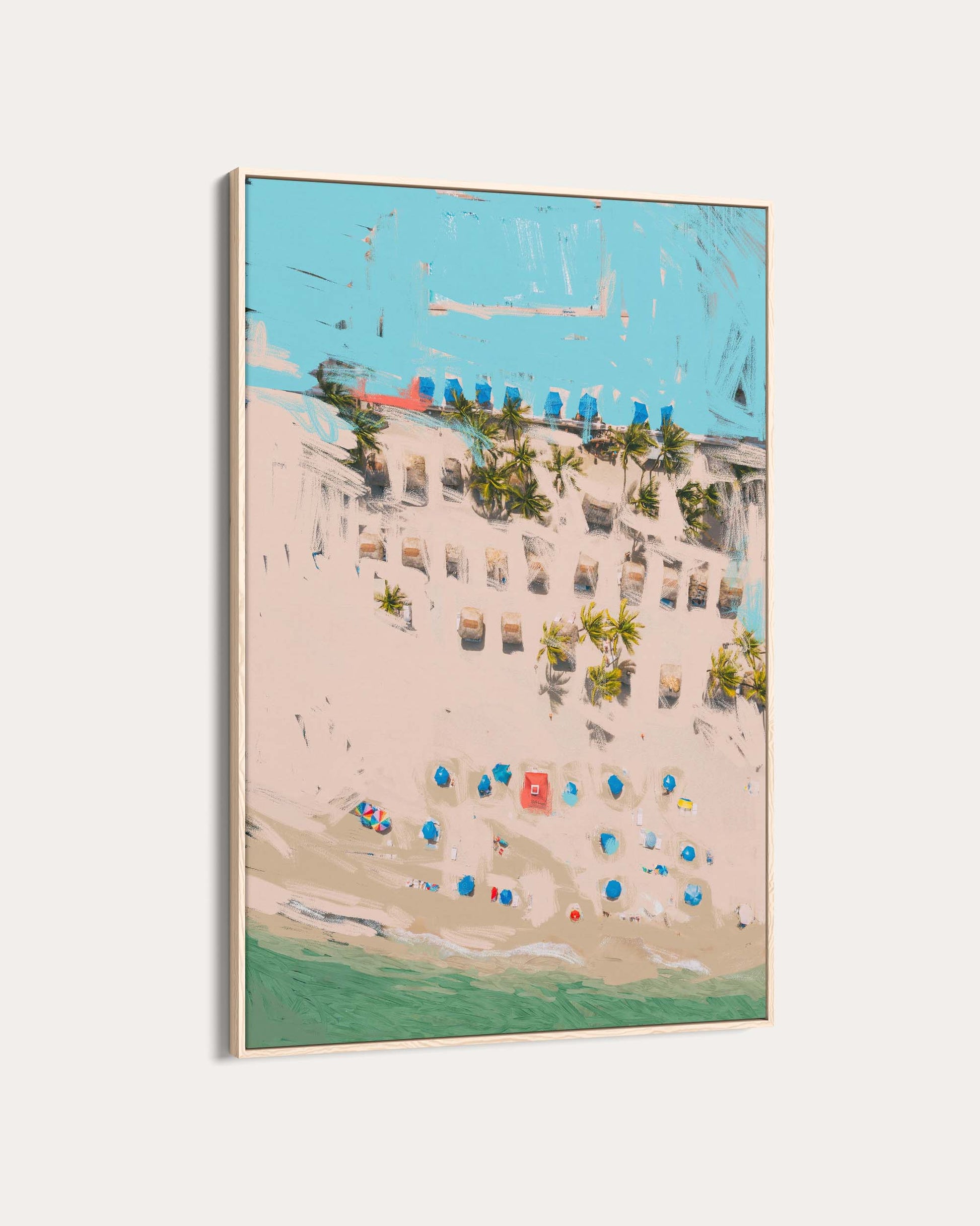 Framed artwork of a beach scene with buildings and palm trees.