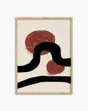 Abstract art print with red and black shapes in a wooden frame on a white background