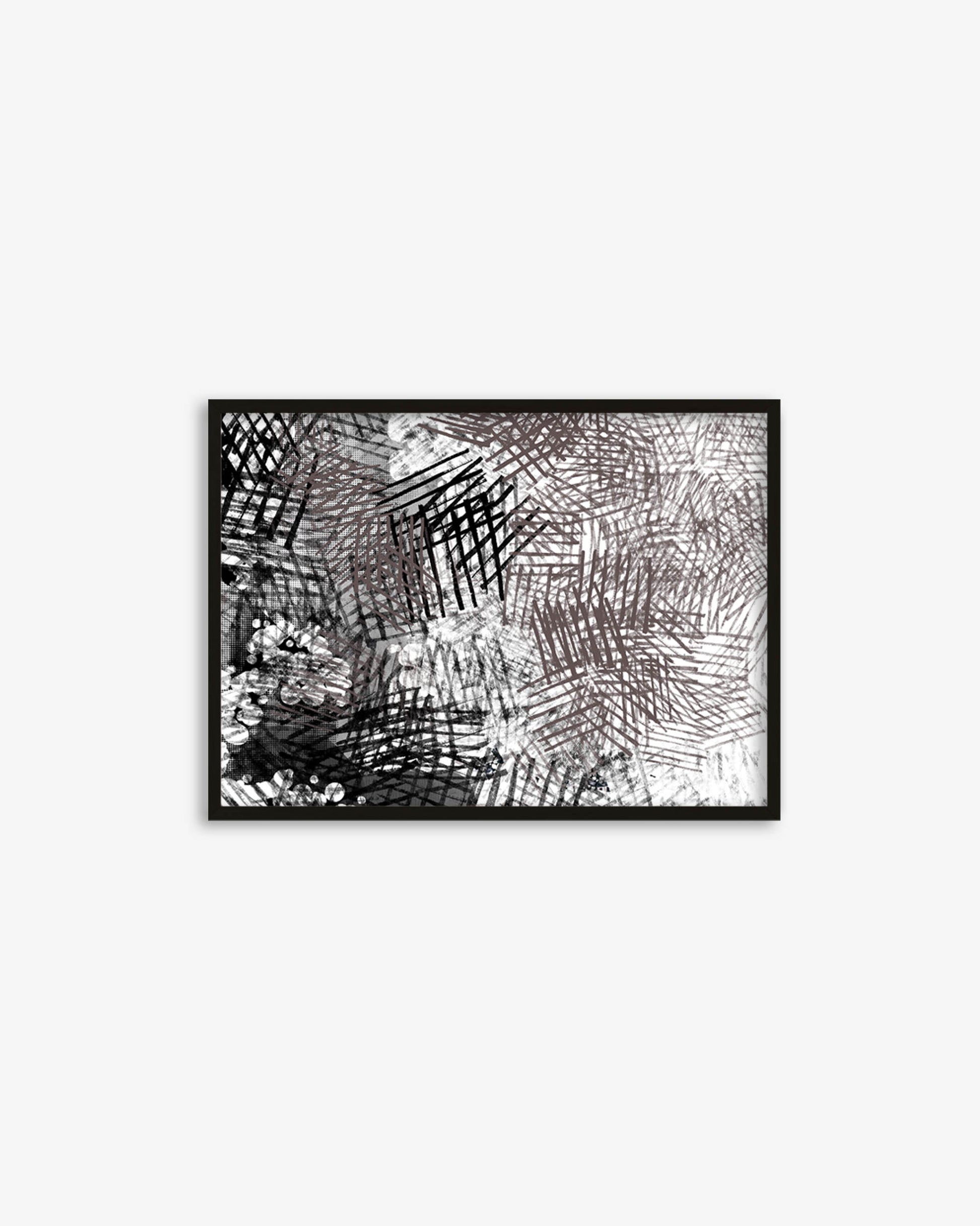Framed black and white abstract artwork on a white wall