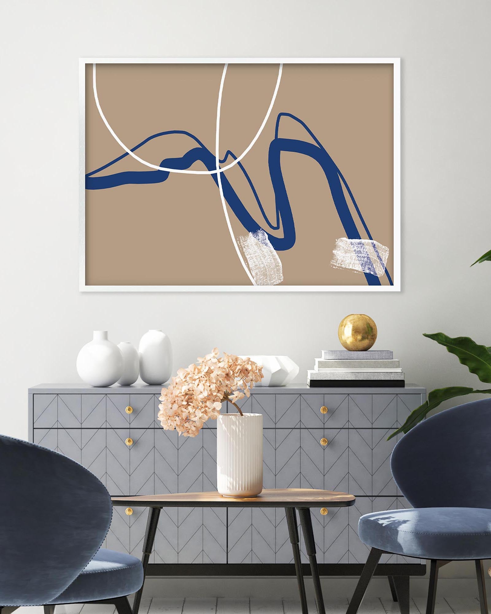 Abstract art piece with blue and white lines on a beige background, displayed in a modern interior setting.