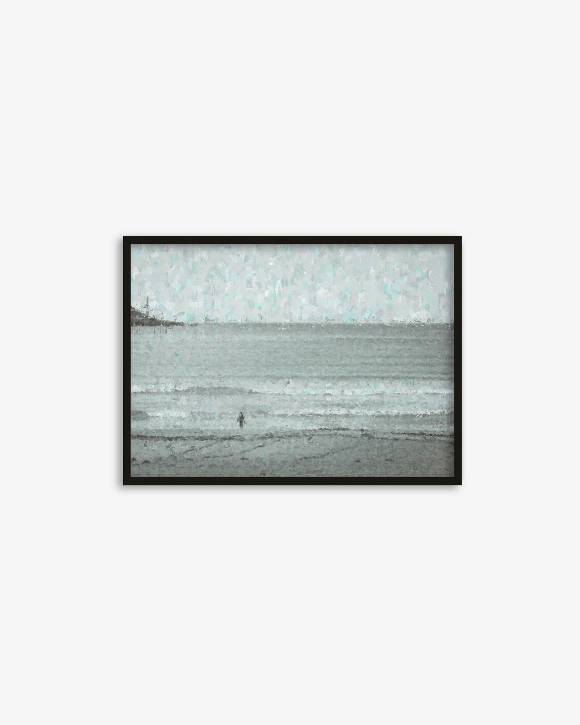 Framed artwork of a beach scene with a person walking on the sand.