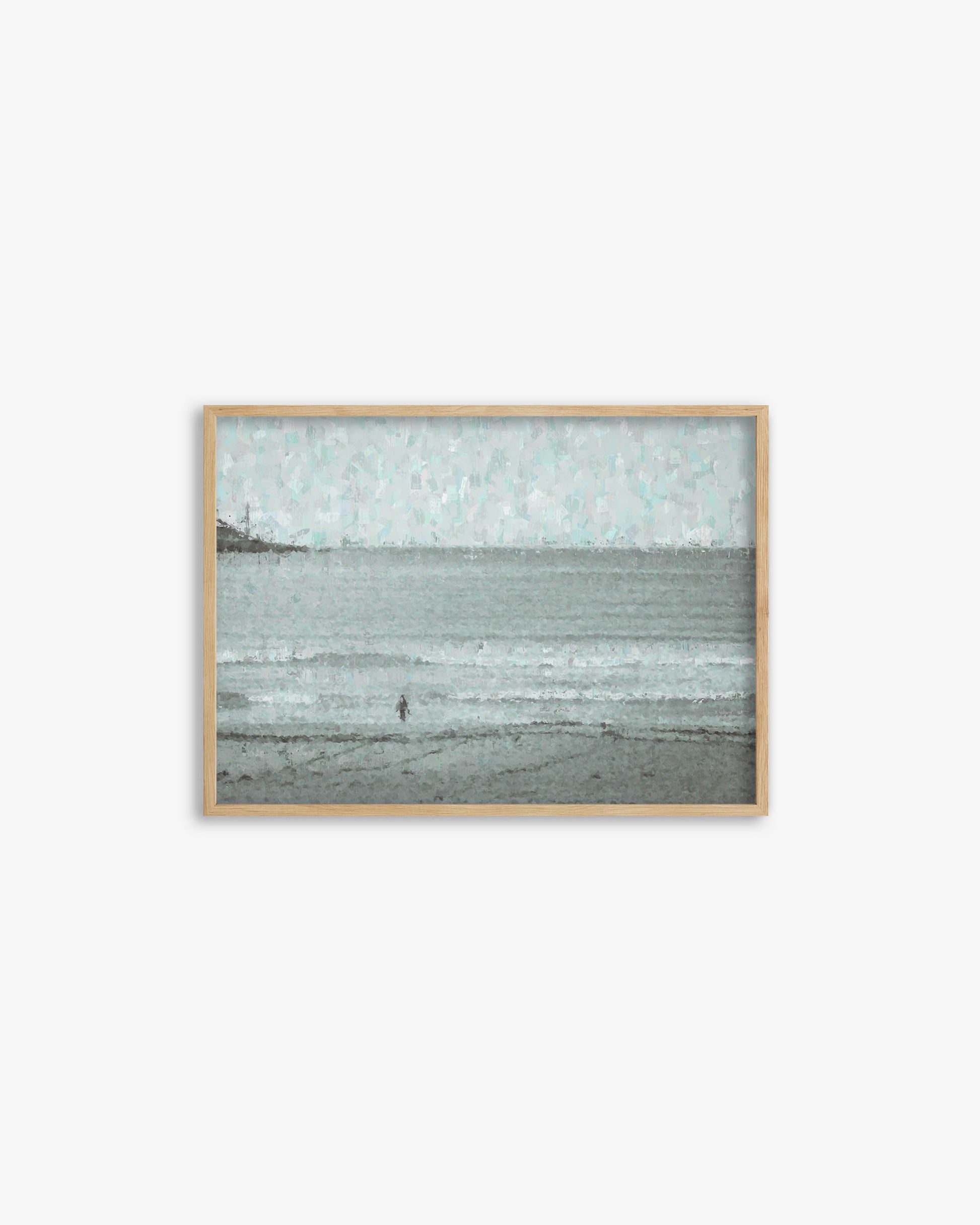 Framed artwork of a landscape with a person on a beach, on a white background