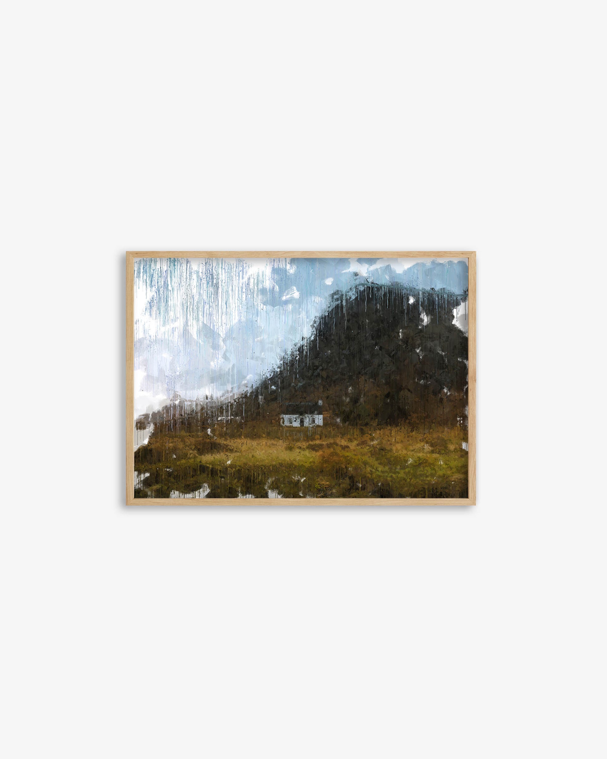 Framed artwork of a mountain landscape with a waterfall on a white wall