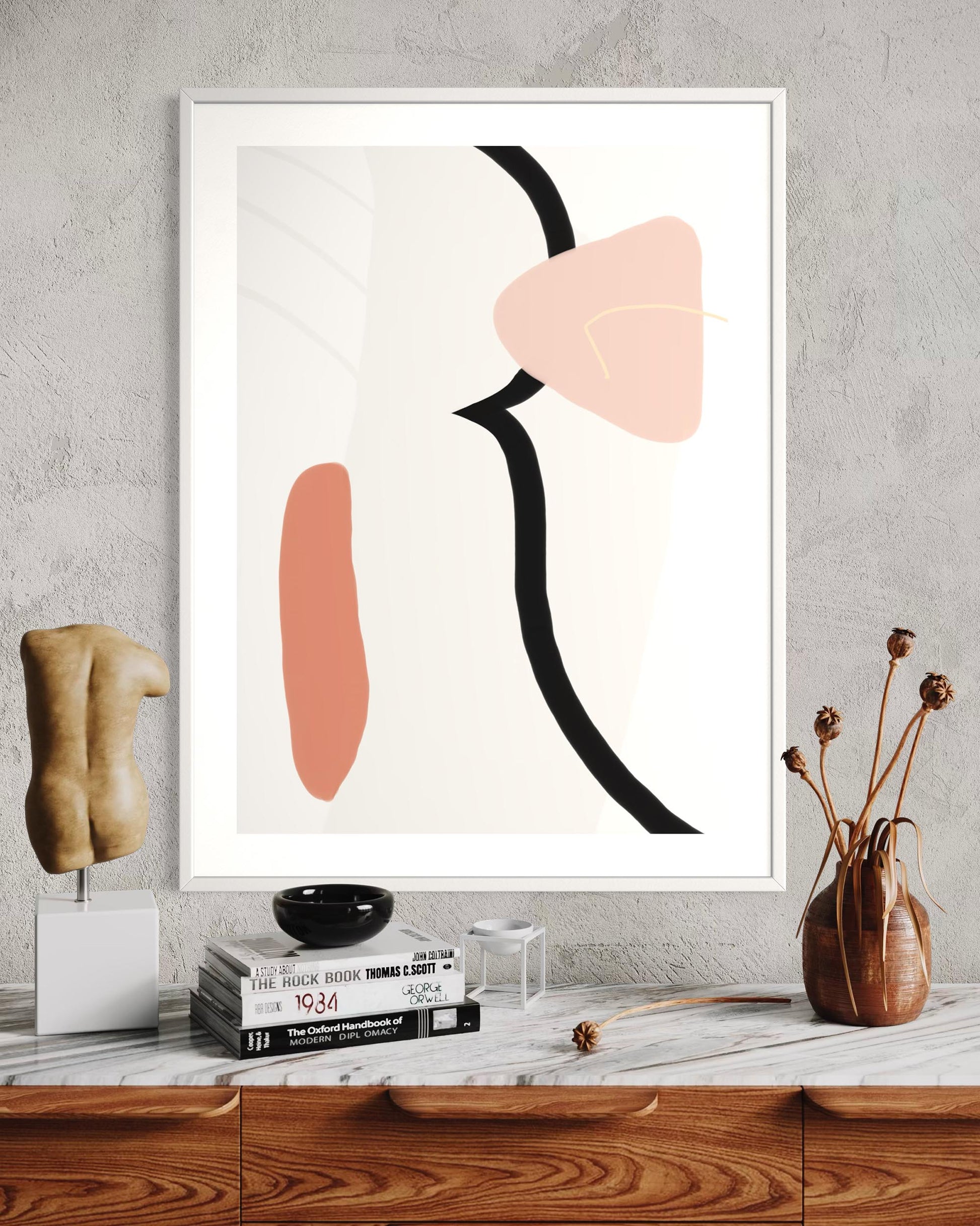 Abstract art print with geometric shapes on a wall above a wooden shelf.