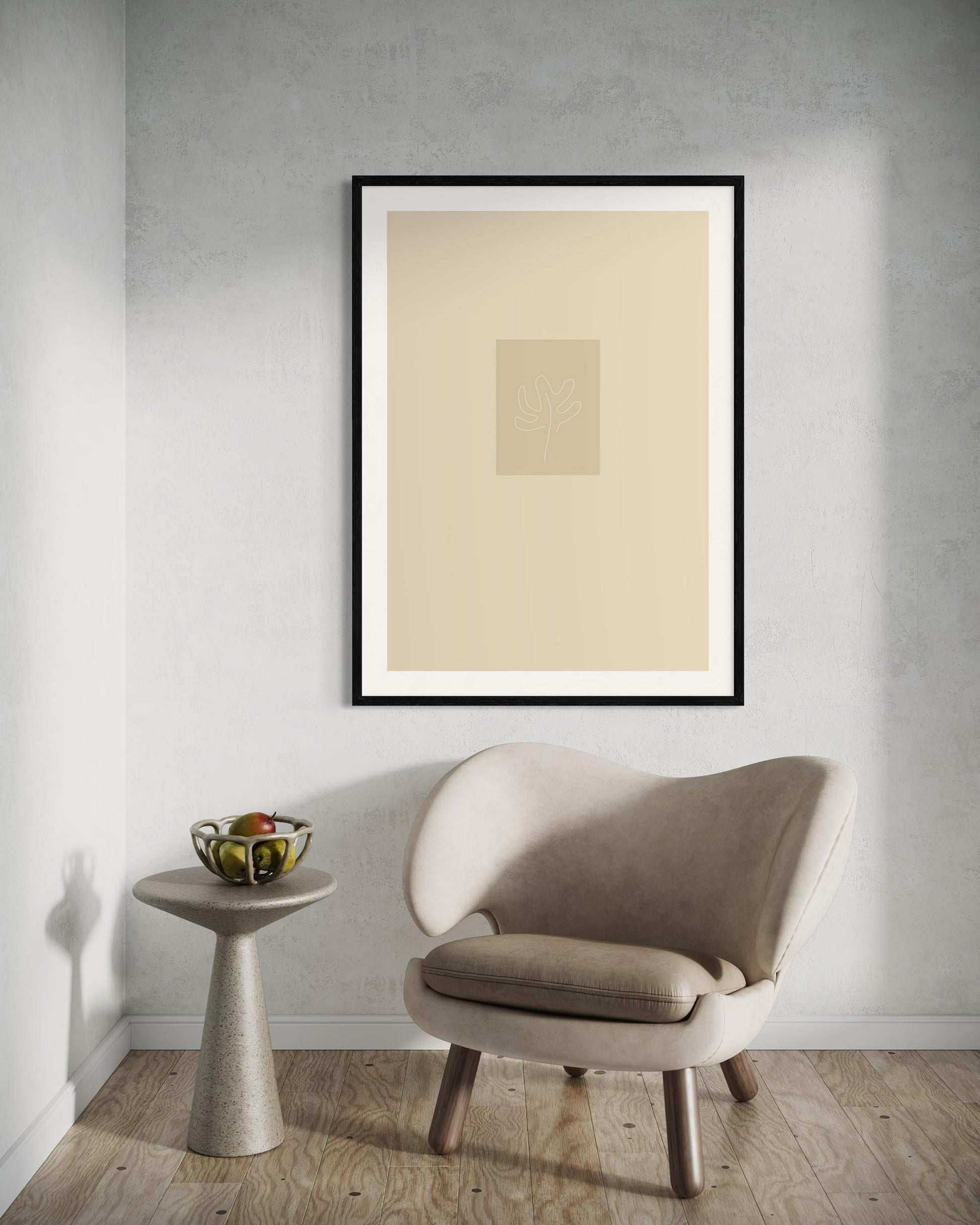 Beige armchair and side table in a room with a framed abstract artwork on the wall.