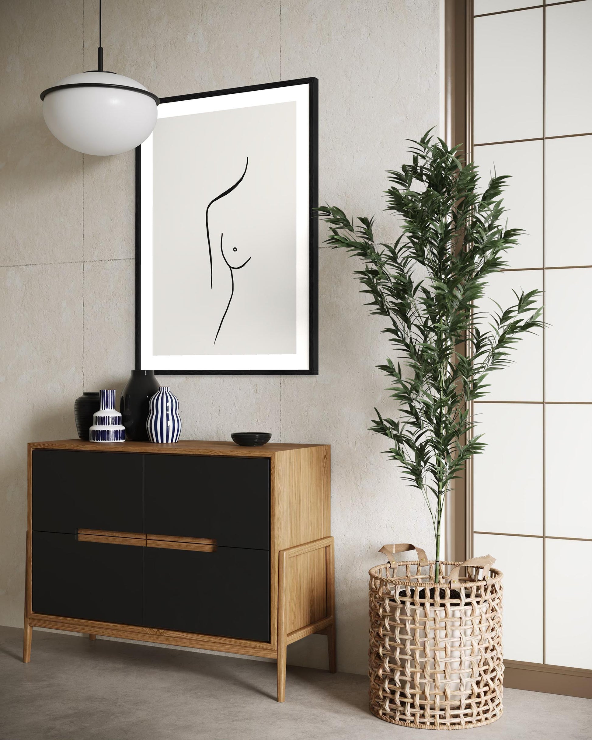 Modern interior with a black and white abstract art print, wooden cabinet, and plant.