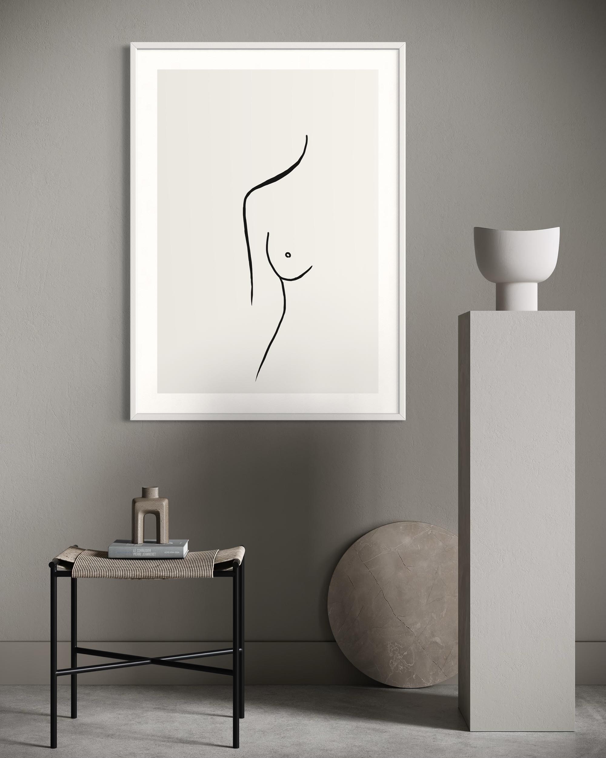 Minimalist black and white abstract art on a gray wall with a side table and sculpture.